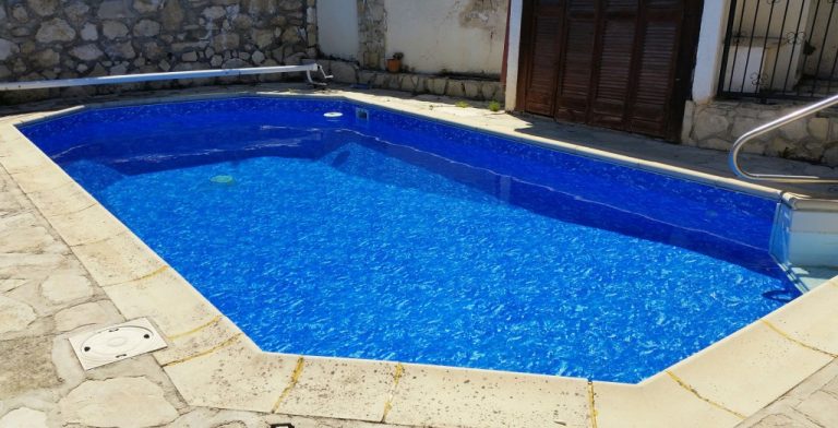 Krásny vonkajší bazén s prelivom, murovaný so skimmerom z fólie MARBLE ALKORPLAN3000 podľa projektovej dokumentácie, farba fólie modro biela mramor, modrá voda